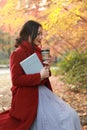 Anonymous woman enjoying takeaway coffee cup on sunny cold fall day Royalty Free Stock Photo